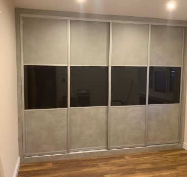 Concrete finish wardrobe with black glass panel accents - Dreamline Interiors