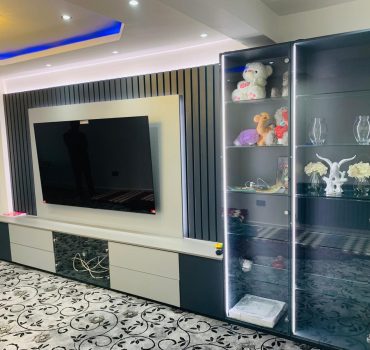 Grey Media Wall with Integrated Glass Cabinets