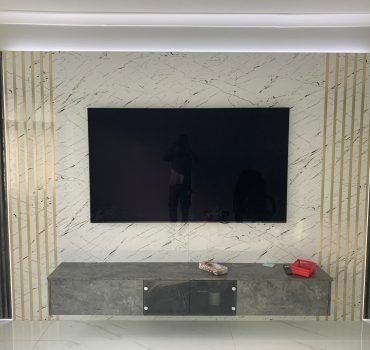 Marble-Inspired Media Wall with Gold Detailing