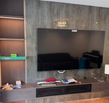 Modern Living Room TV Wall with Gloss Finish and Side Shelves