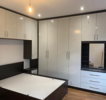 White wardrobe with black frame and central mirrored sliding door - Dreamline Interiors